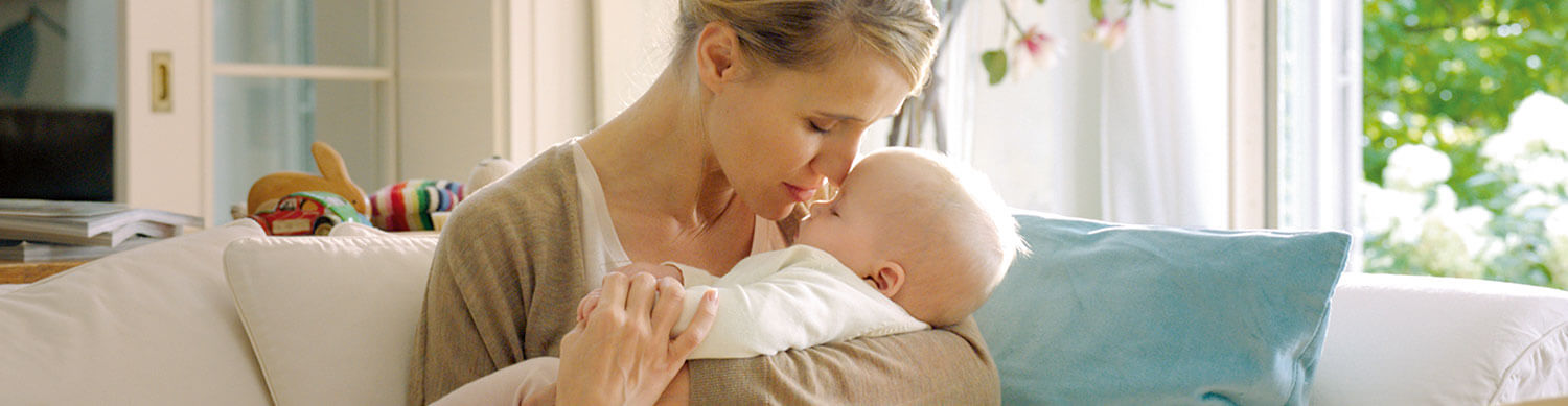 A woman is holding a baby.
