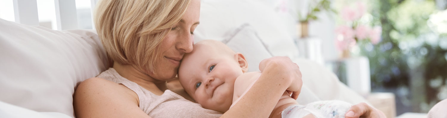 A woman is holding a baby.