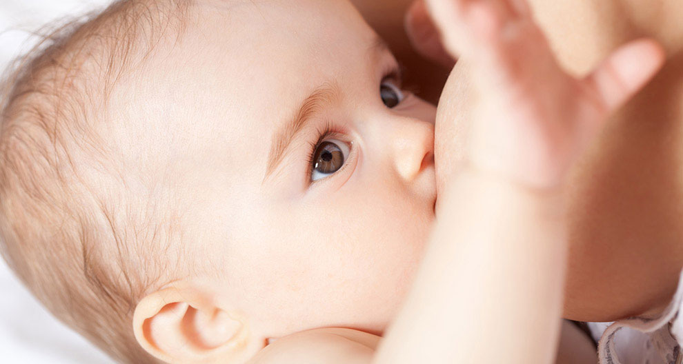 A close-up of a baby's face, with one eye visible, looking towards the camera.